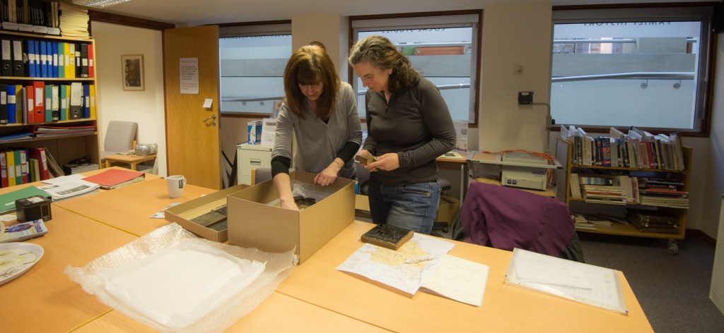 Harriet and Fiona Rosher of the Dales Countryside Museum looking at the Marie Hartley collection of wood engravings.